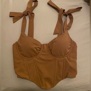 Brown corset top with zip-up back and straps that tie